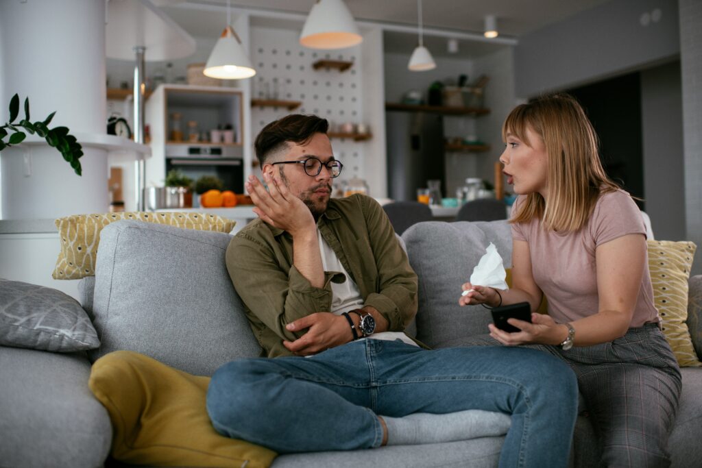 A couple argues on the couch